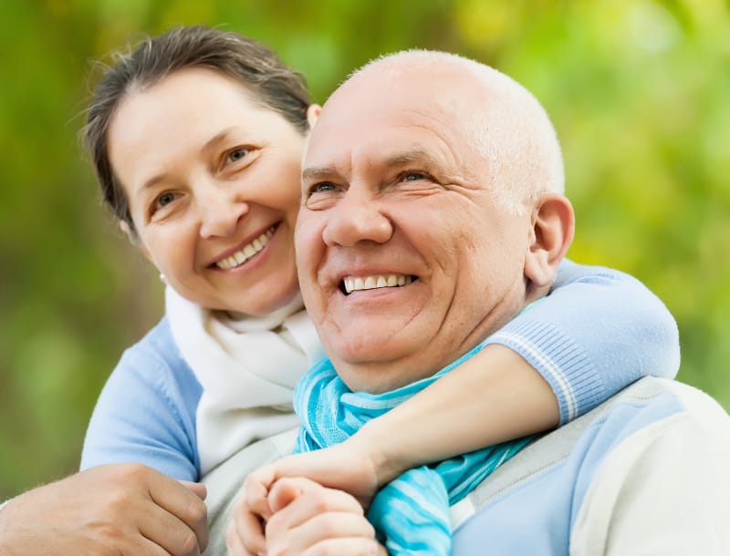 smiling couple with amazing teeth they are happy to smile with as they are smiling and smiling.
